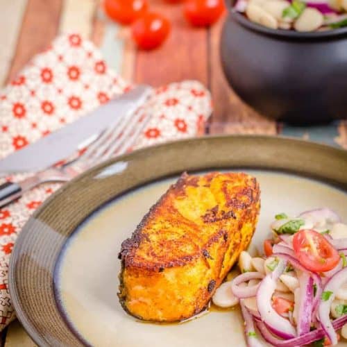 A plate of pan seared tandoori salmon with some lima beans salad. It is a healthy, quick and easy recipe