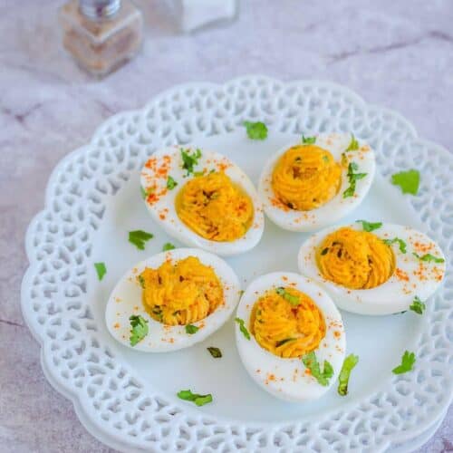 Curried deviled eggs are seasoned with curry powder garam masala and chili powder. Great side dish and a starter