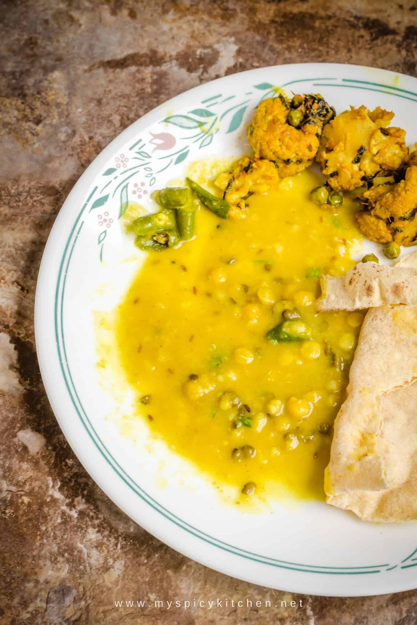 Plate of dal with roti and cauliflower