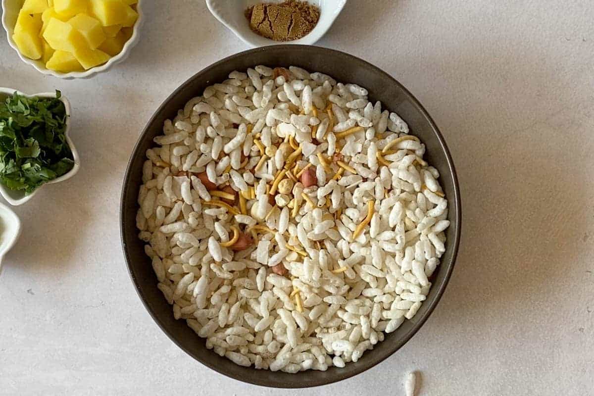 Bowl of puffed rice, sev, peanuts, fried gram and coconut mixture.