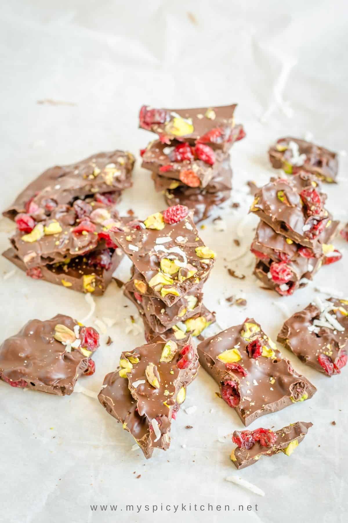 Stacks of dark chocolate bark on parchment paper.