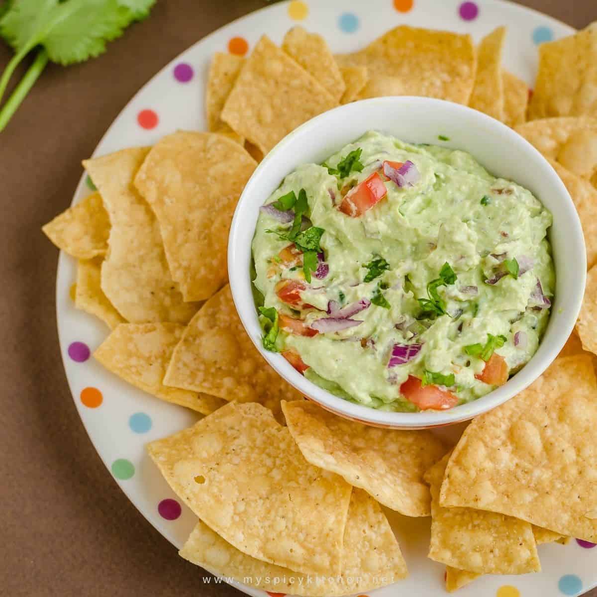 Bowl dip and chip on a plate.