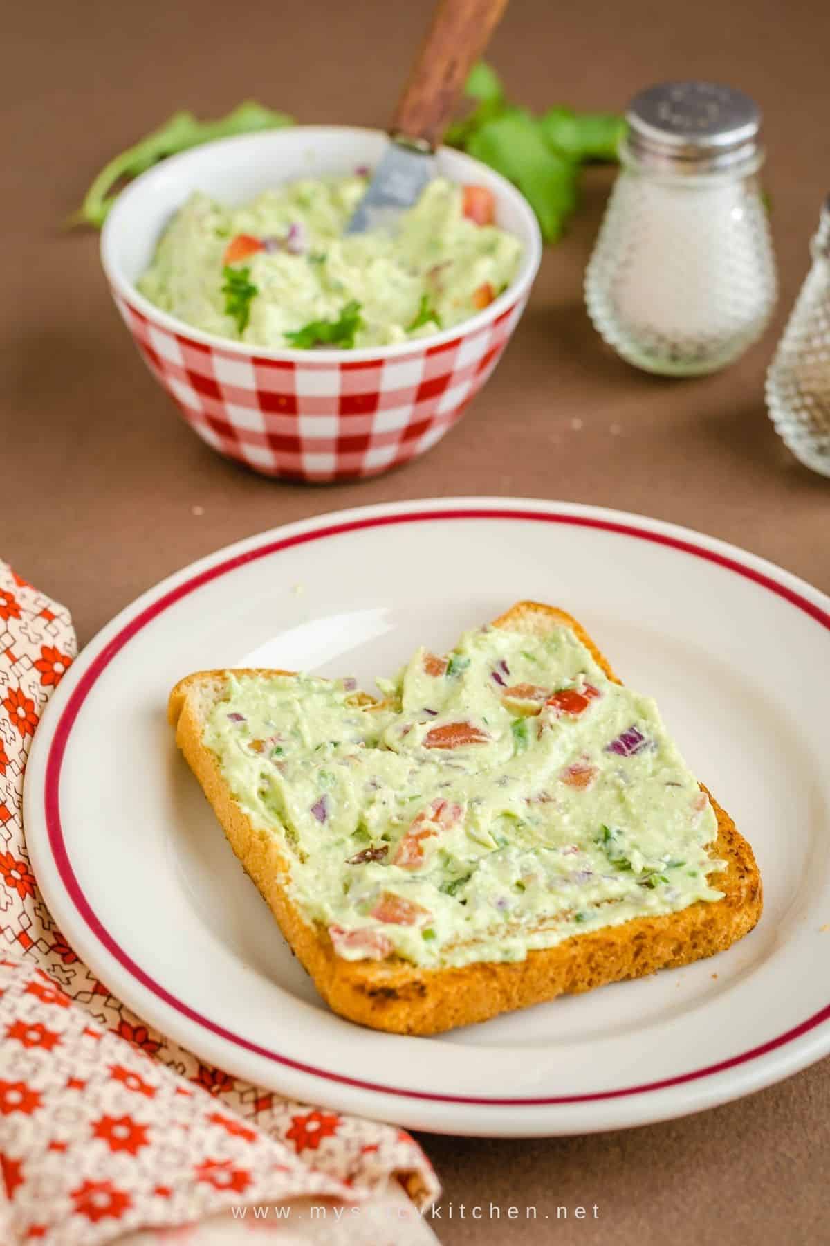 Open sandwich with guacamole cottage cheese spread.